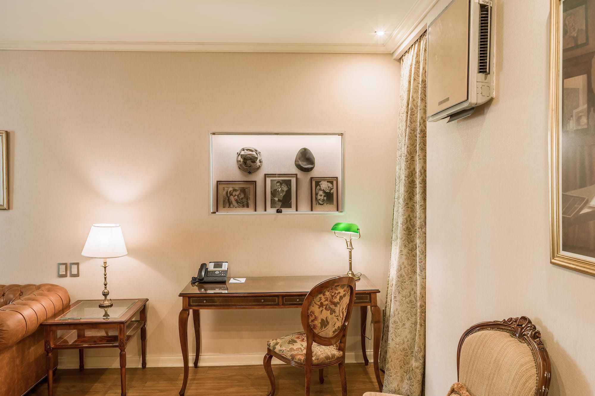 a room with a desk and chairs