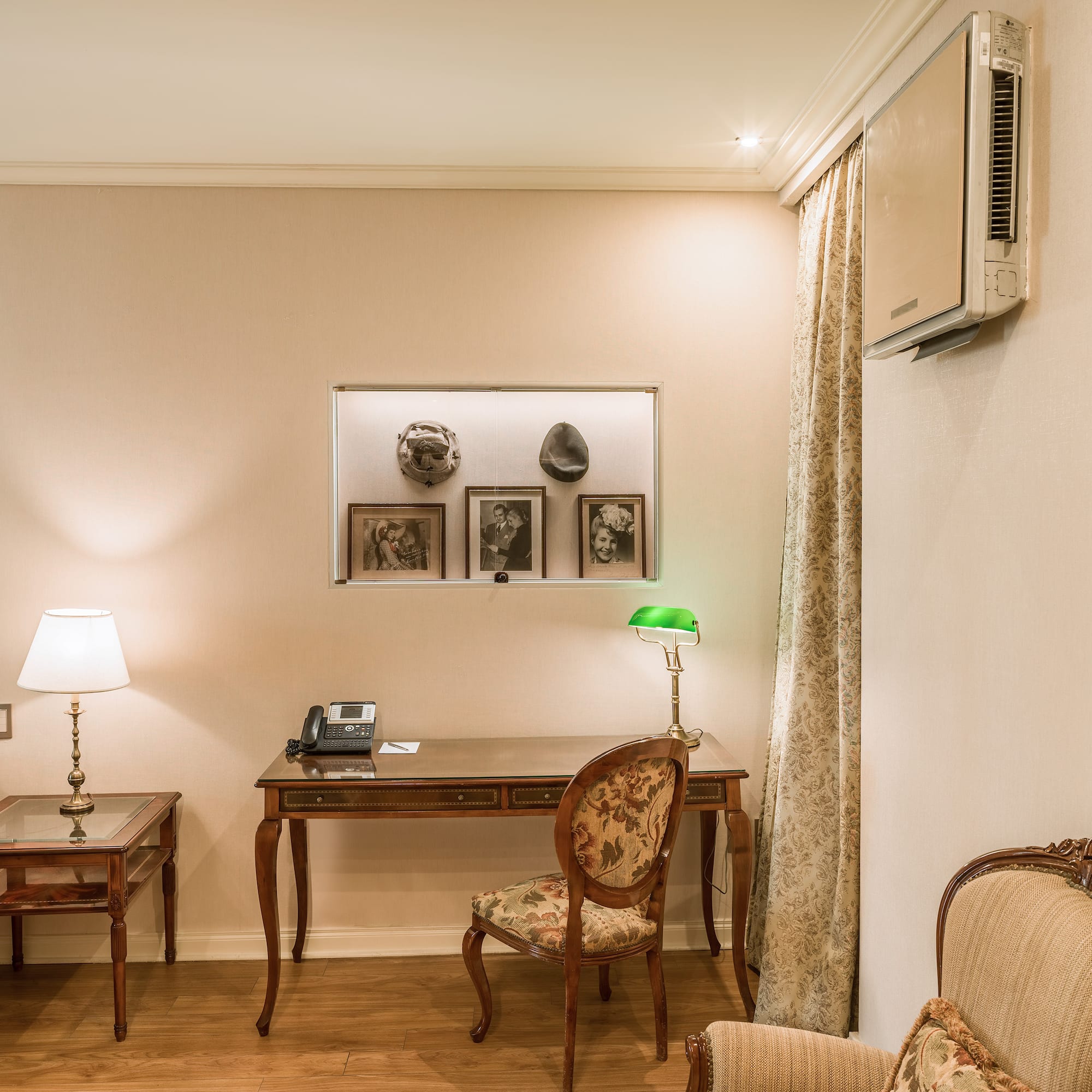 a room with a desk and chairs