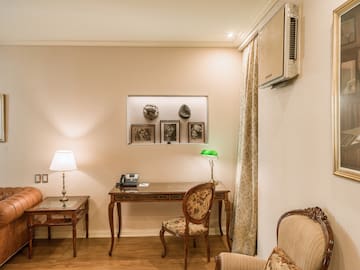 a room with a desk and chairs