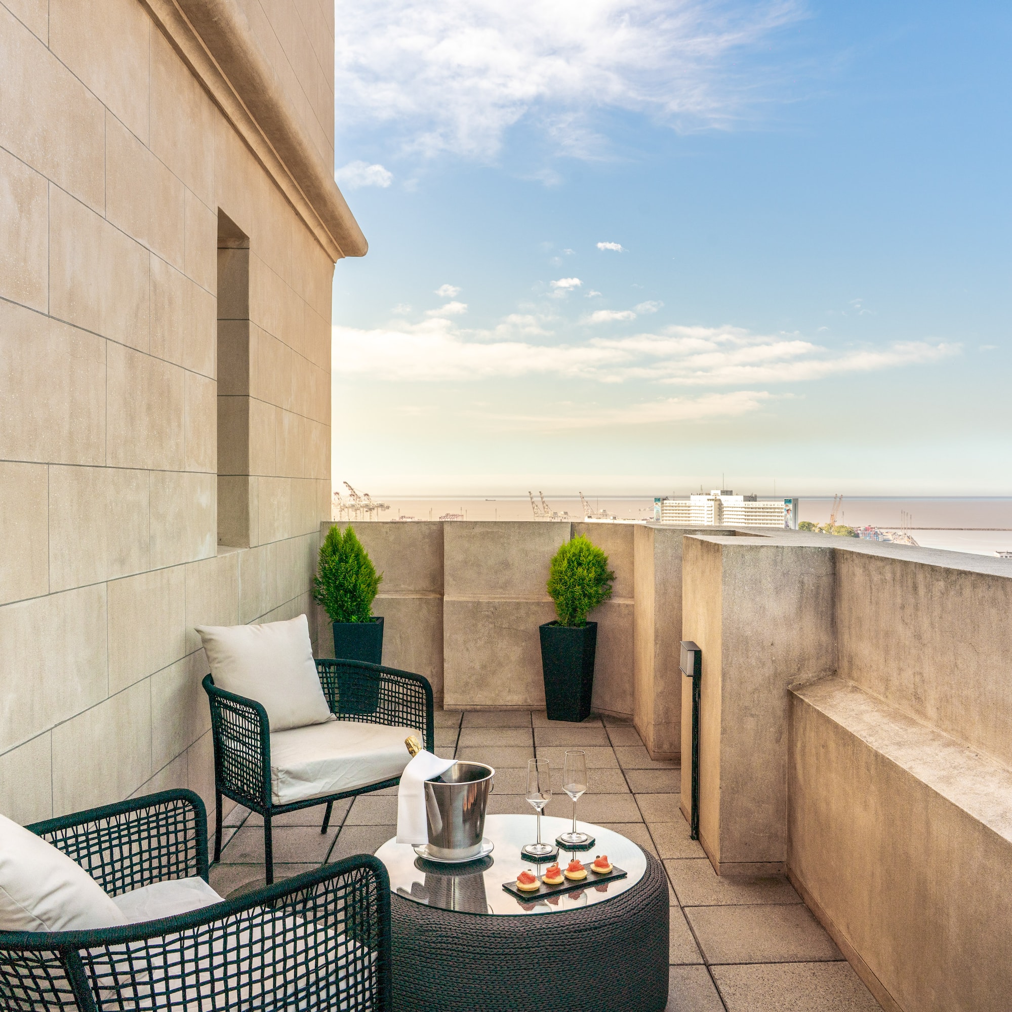 a patio with chairs and a table