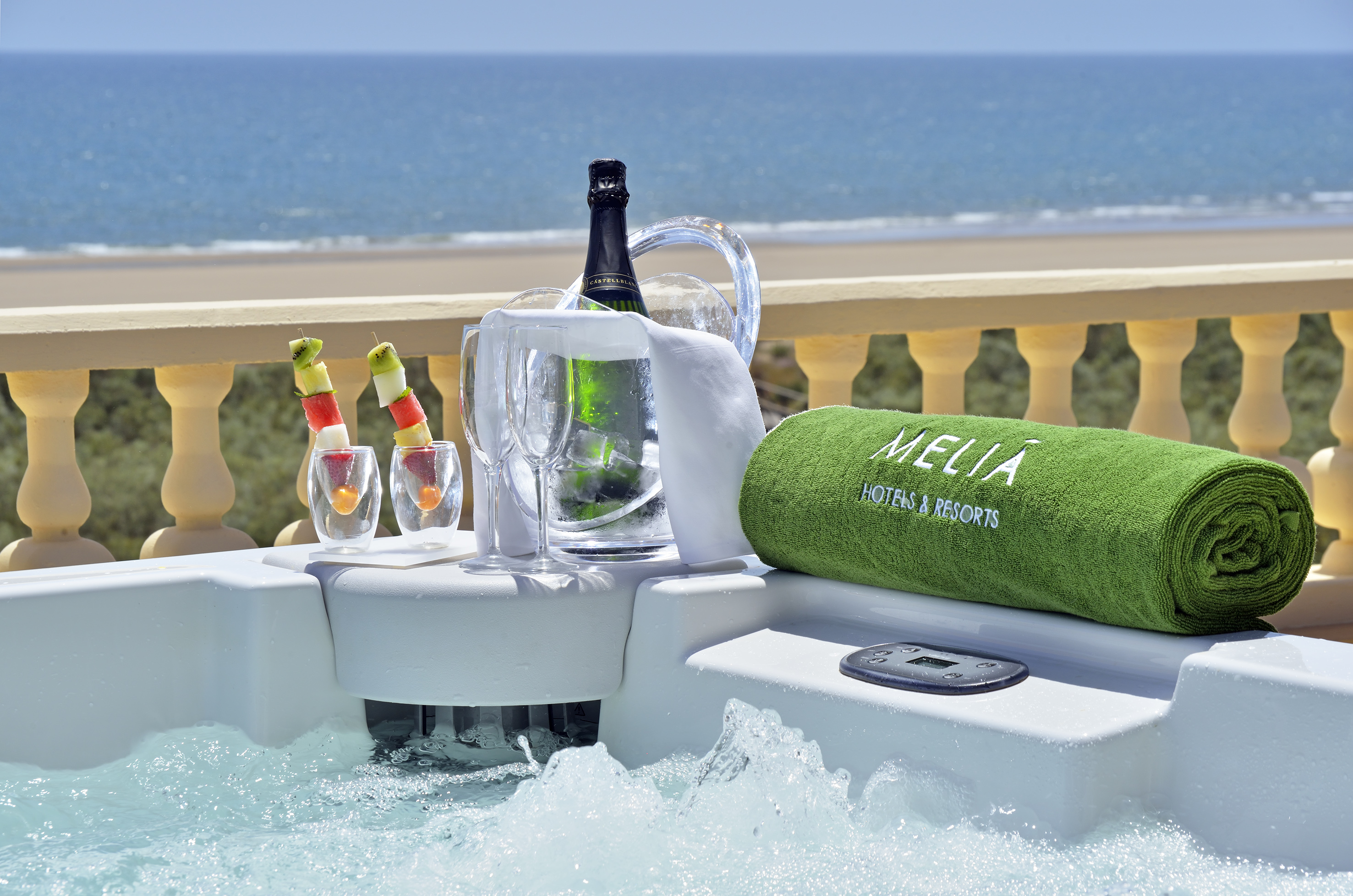 Luxury hot tub with ocean view, champagne, fruit, and Melia resort towel.
