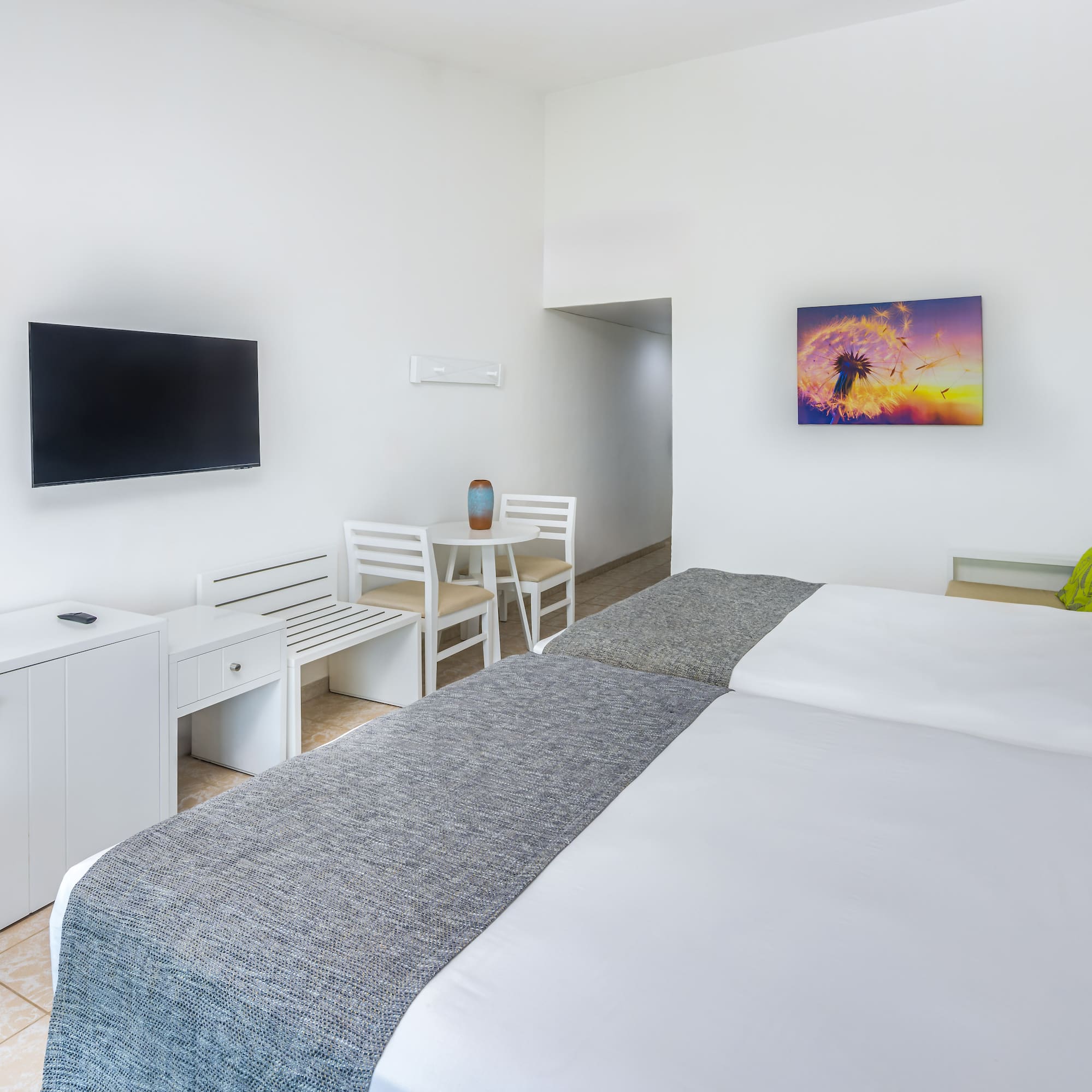 a room with a bed and a television