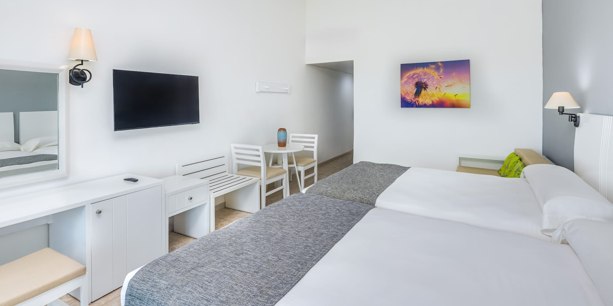 a room with a bed and a television