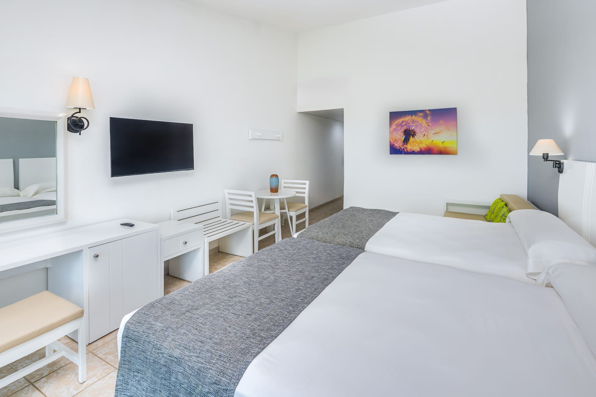 a room with a bed and a television