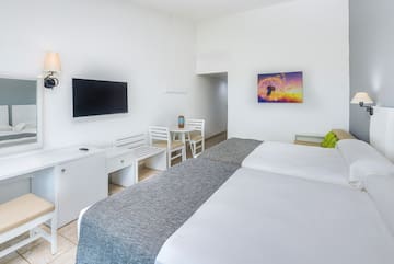 a room with a bed and a television