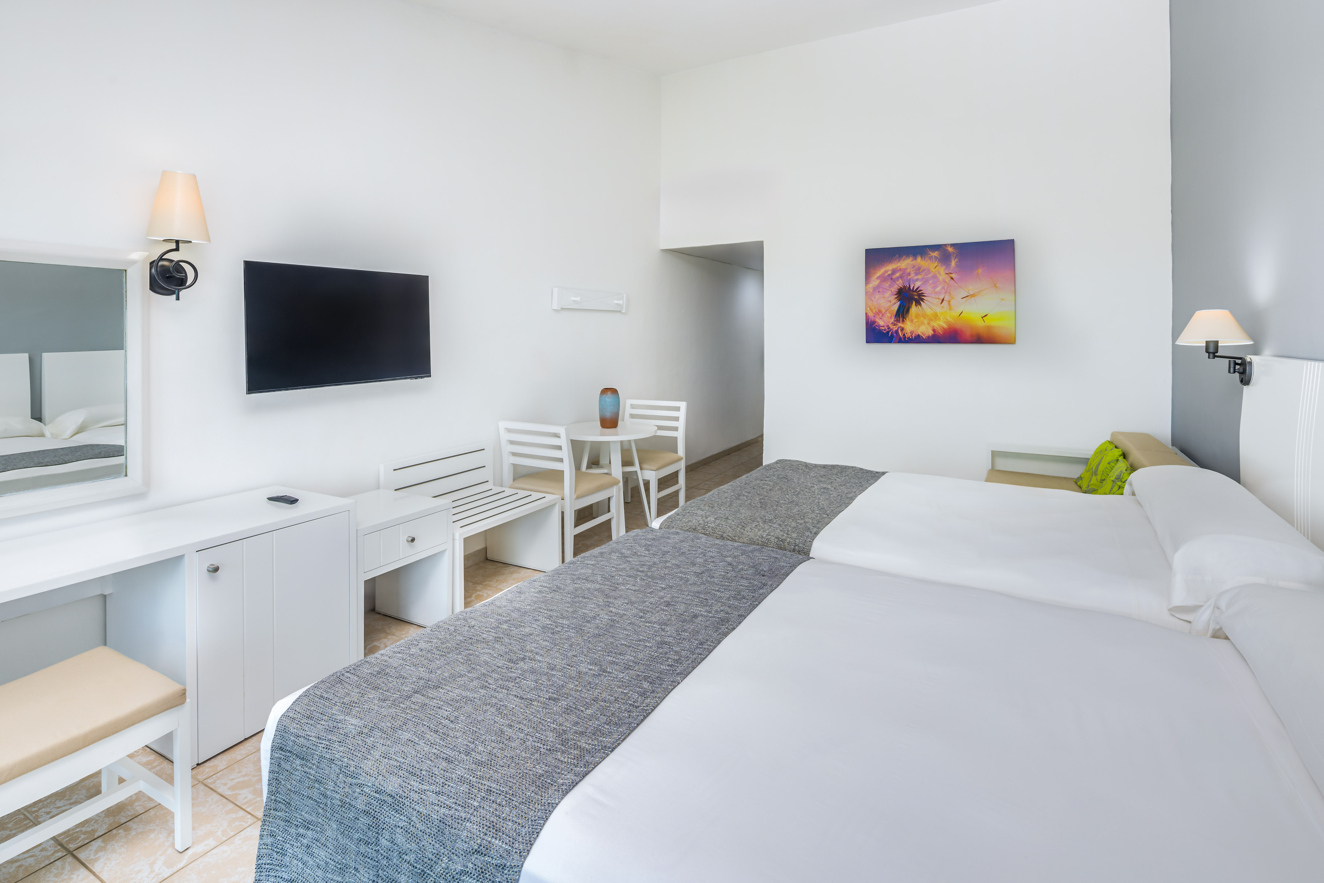 a room with a bed and a television