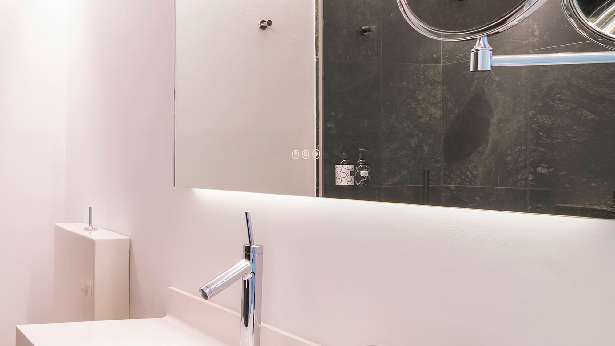 a bathroom with a mirror and a sink