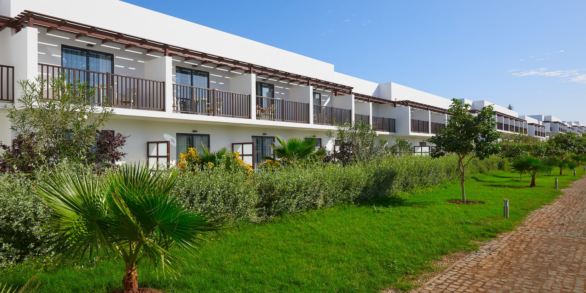 a building with trees and grass