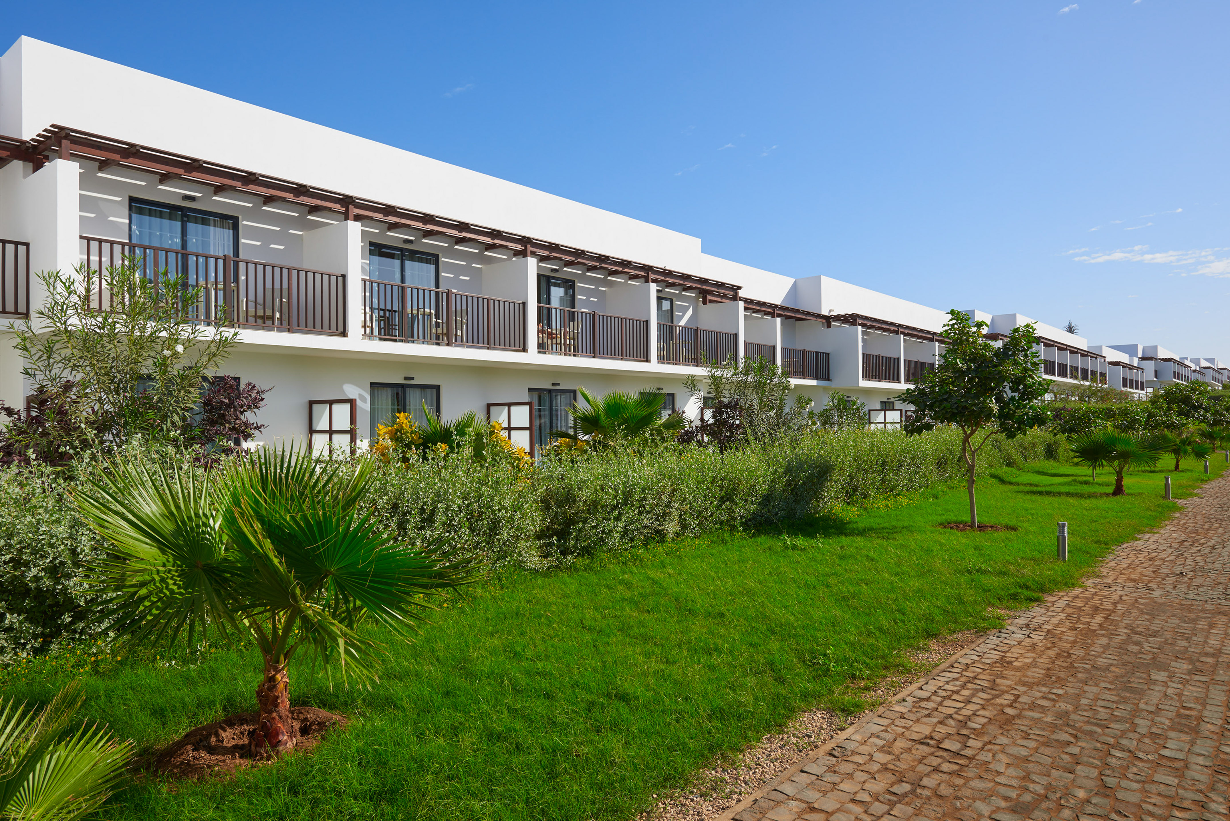 a building with trees and grass