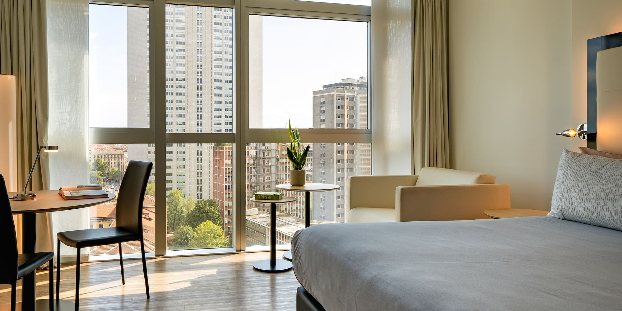 a room with a bed and chairs and a table