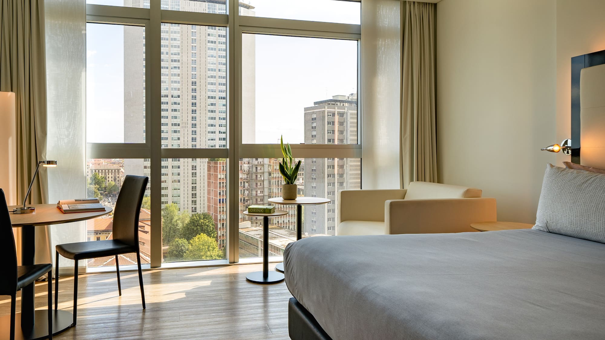 a room with a bed and chairs and a table