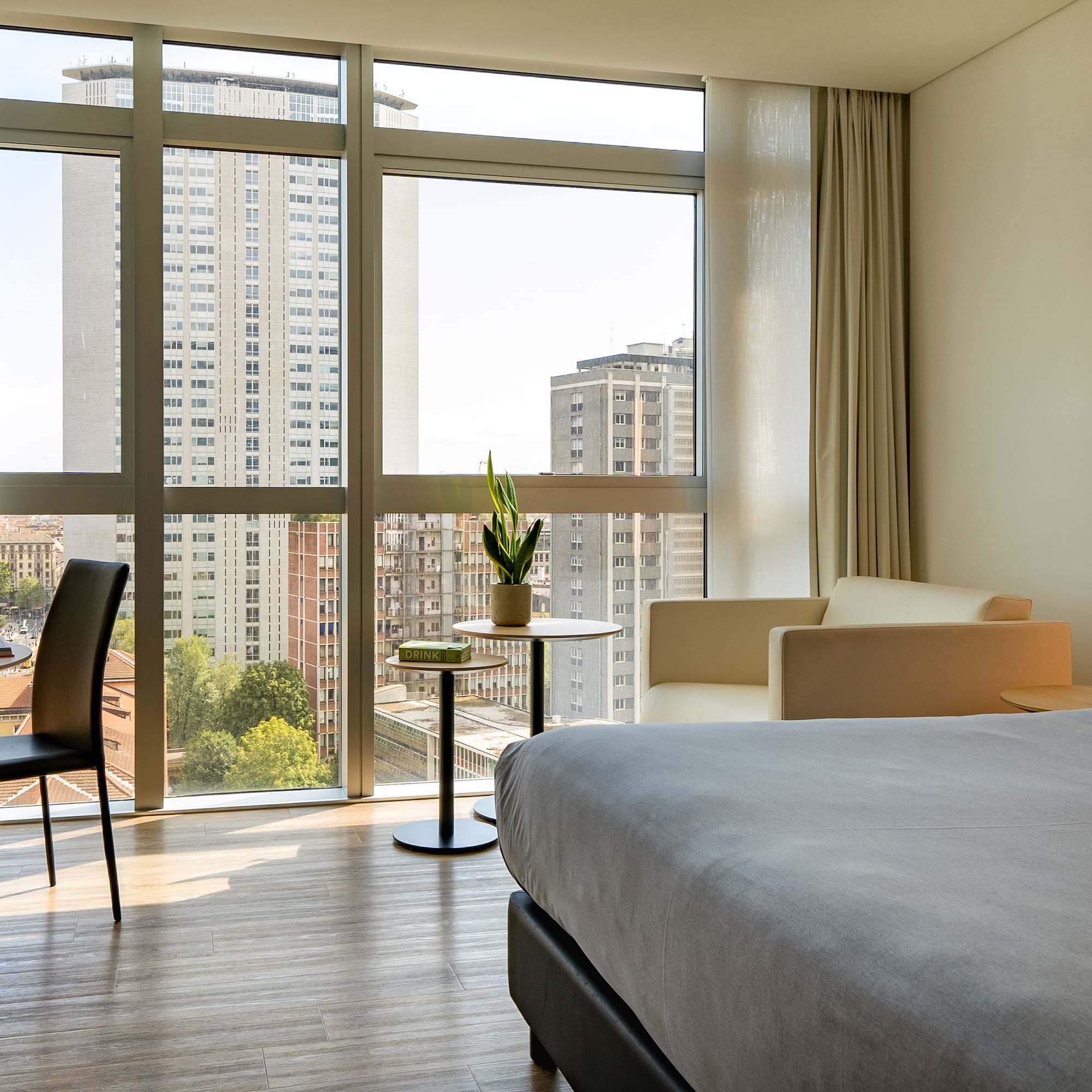 a room with a bed and chairs and a table