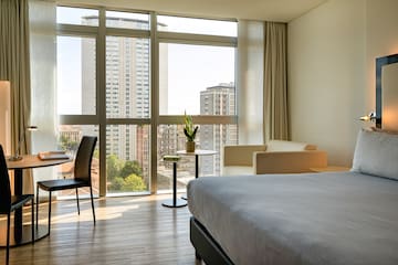 a room with a bed and chairs and a table