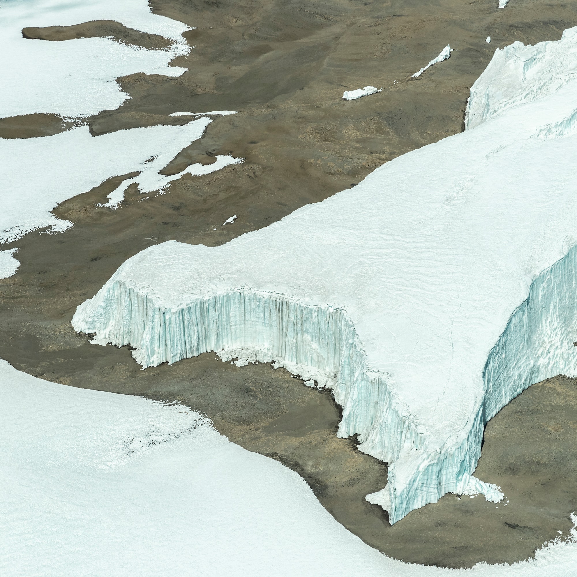 a snow covered ground and a glacier