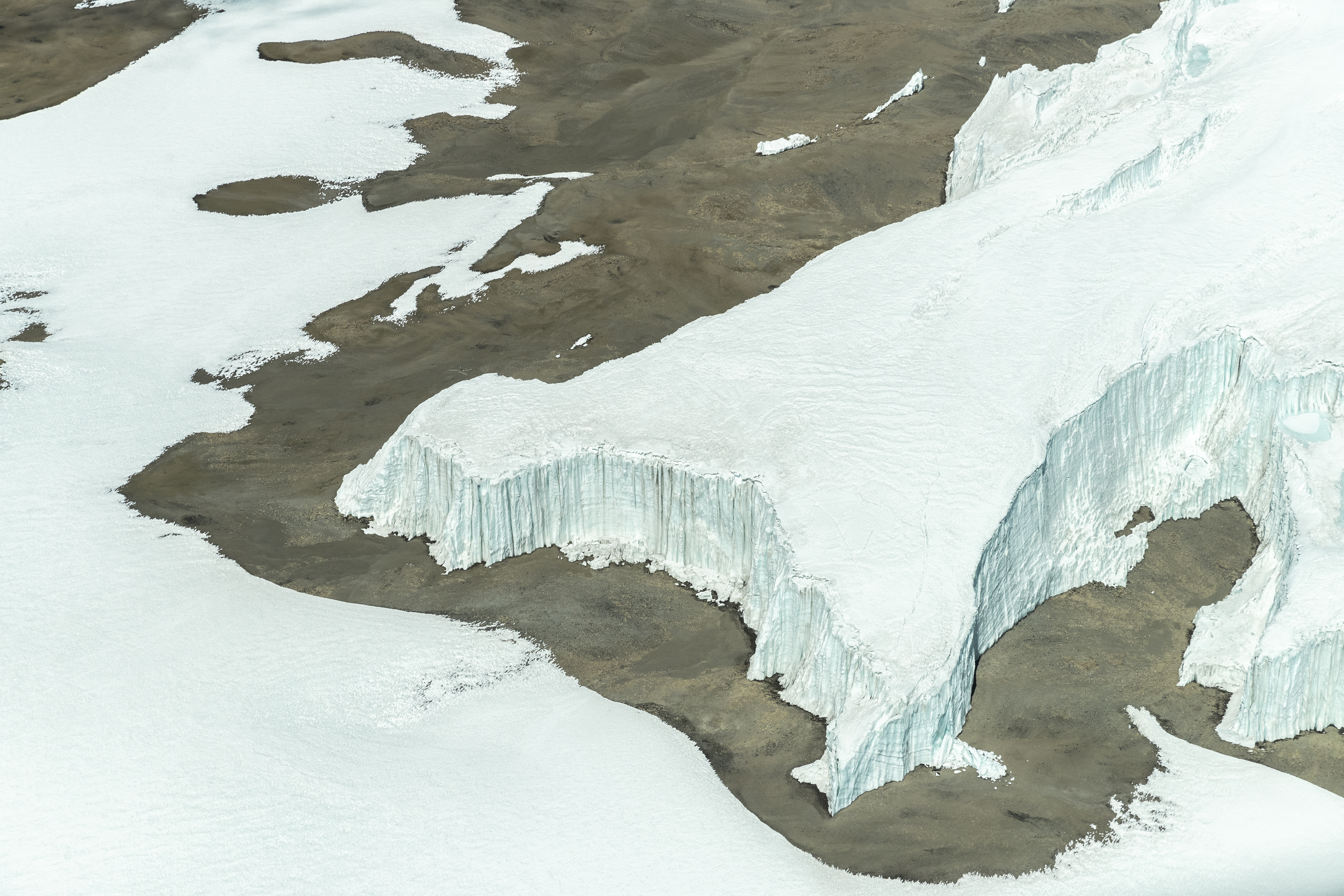 a snow covered ground and a glacier