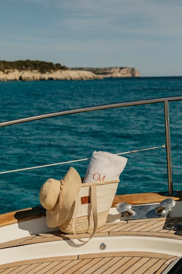 a hat and towel on a boat