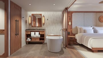 a bathroom with a bed and a tub