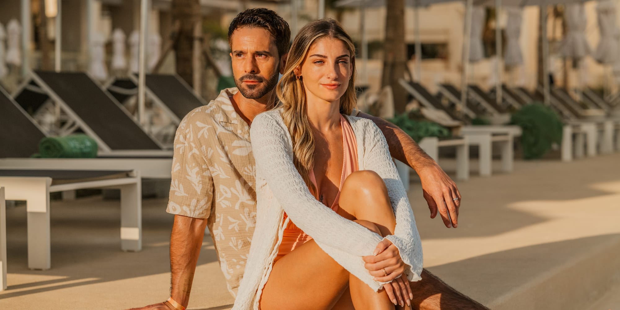 a man and woman sitting on a ledge