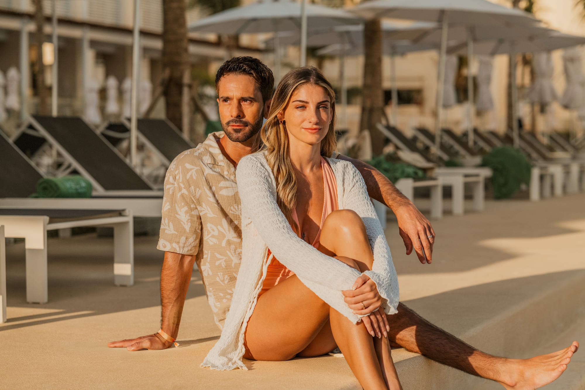 a man and woman sitting on a ledge