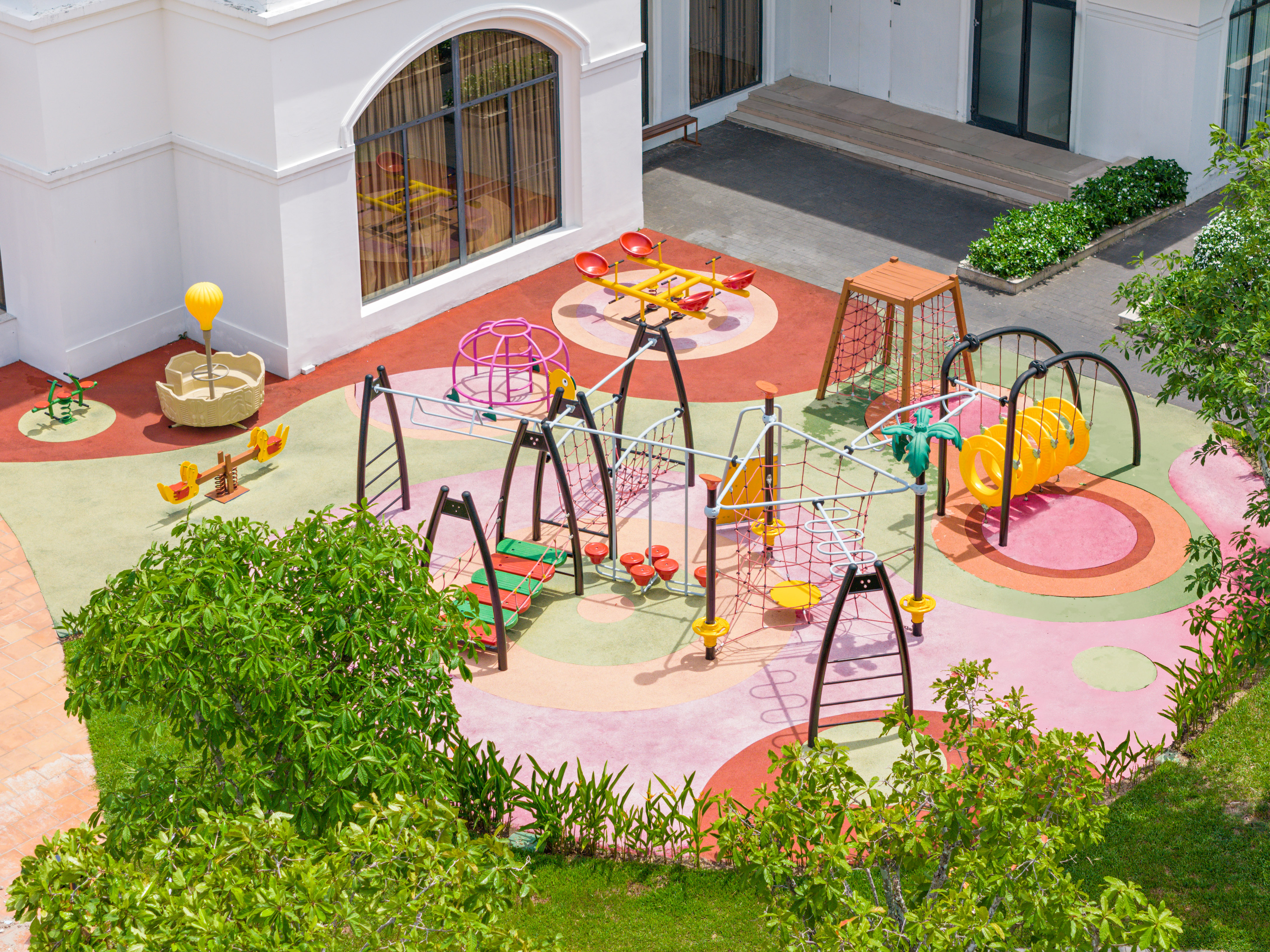Vibrant outdoor children's playground with slides, swings, and climbing frames.
