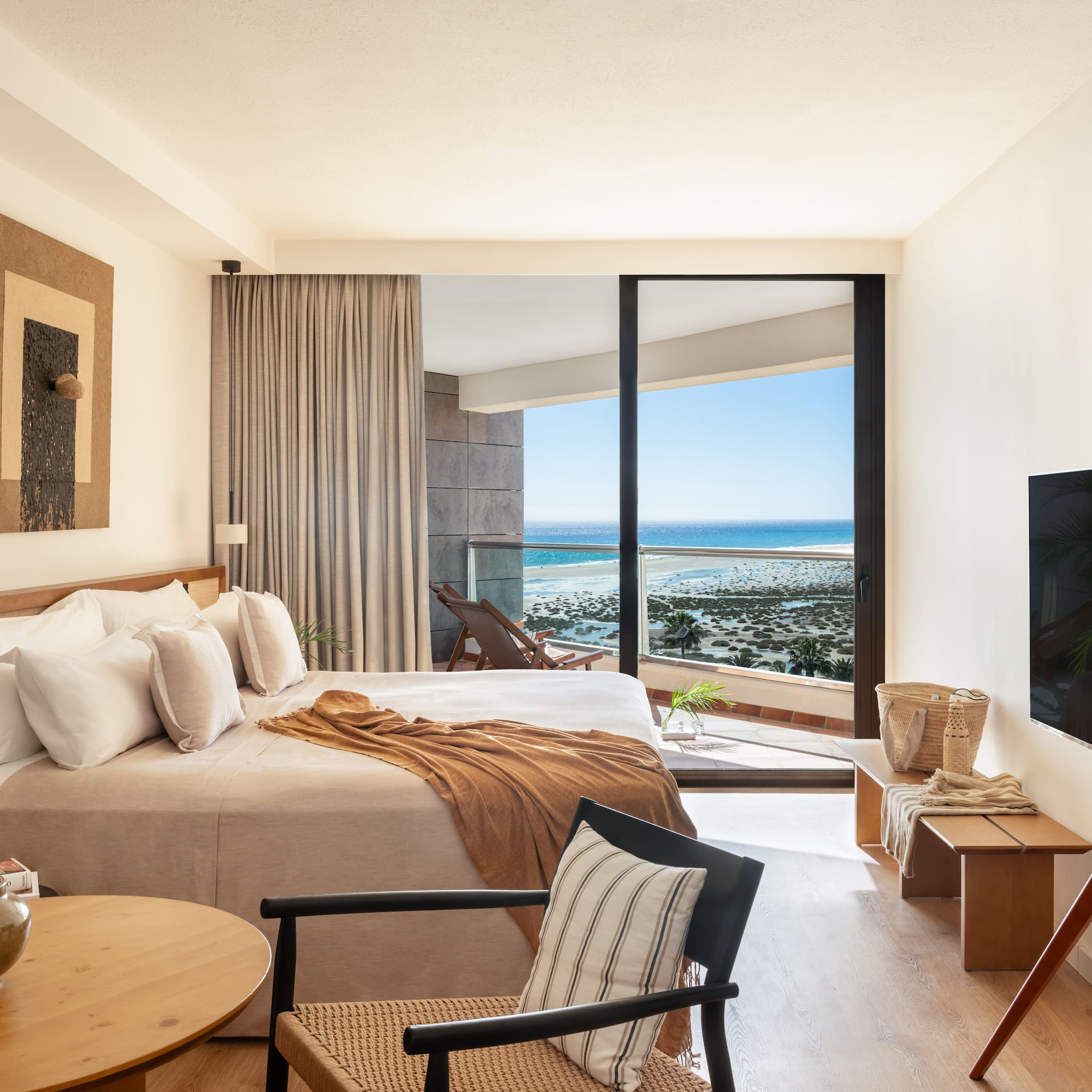 a bedroom with a large glass door and a bed