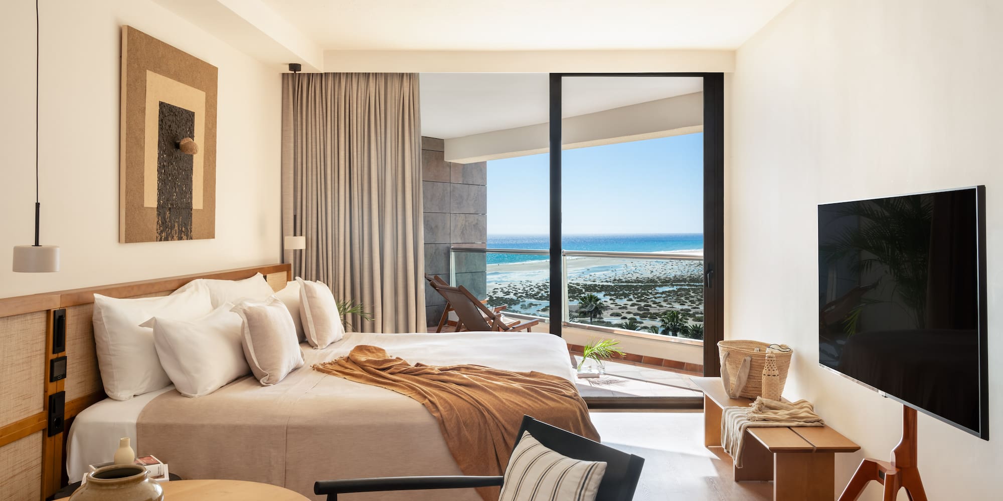 a bedroom with a large glass door and a bed