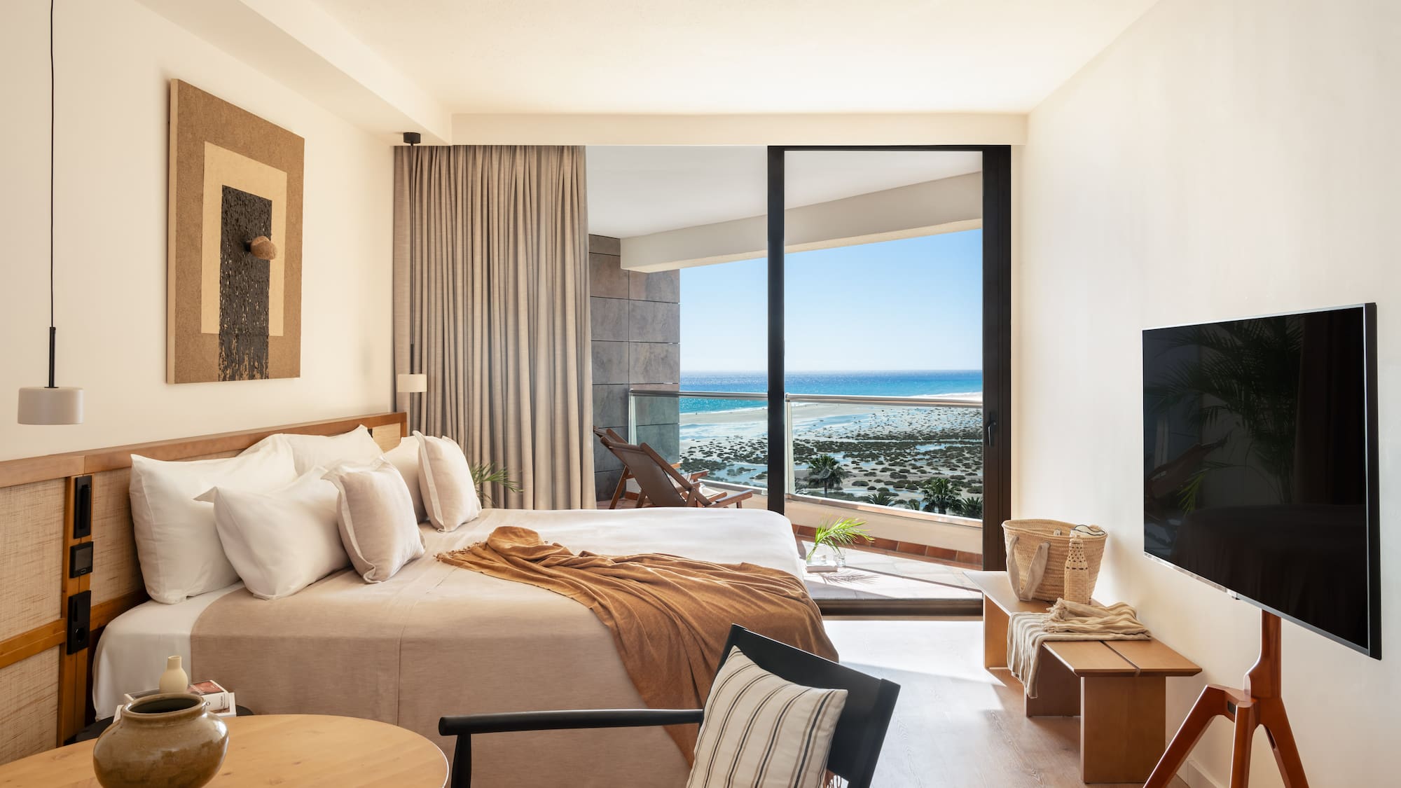 a bedroom with a large glass door and a bed