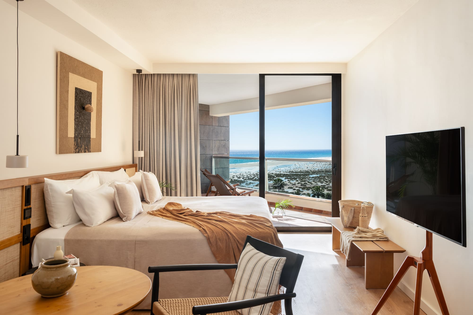 a bedroom with a large glass door and a bed