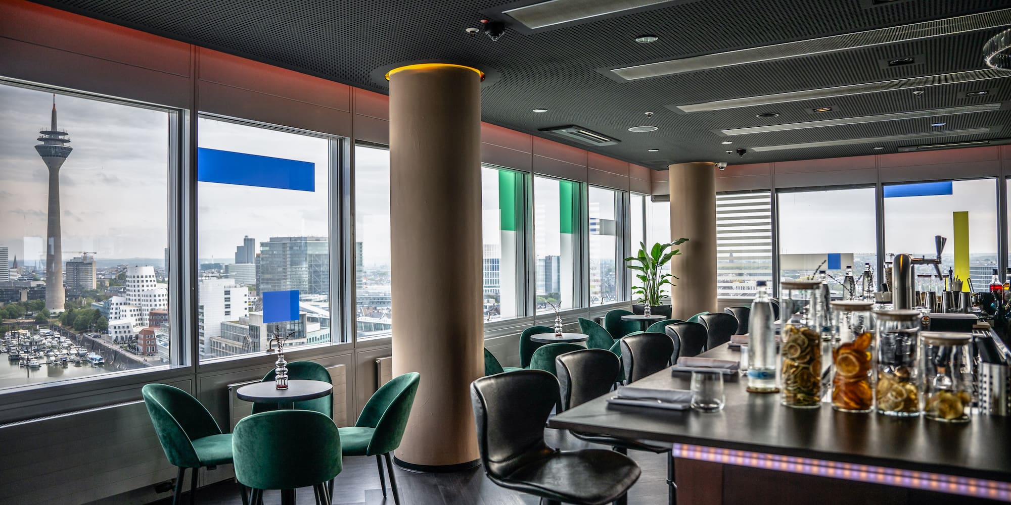 a room with a table and chairs and a tall column