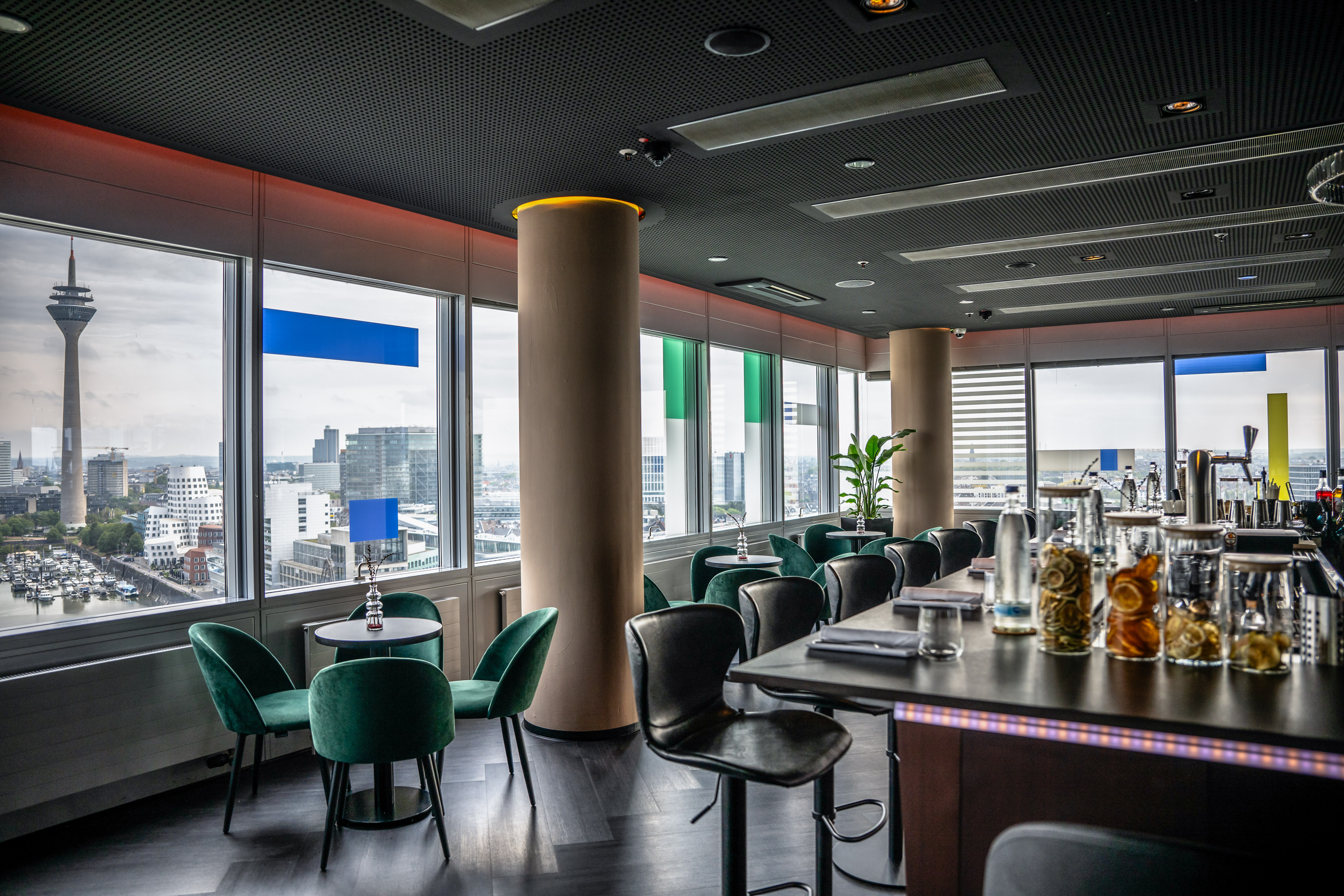 a room with a table and chairs and a tall column