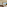 Luxury hotel suite overlooking ocean, modern decor, balcony, and palm trees.