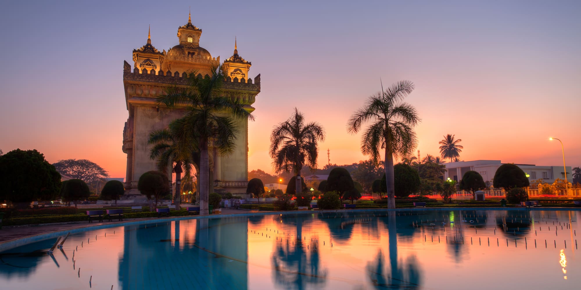 a large building with a pool in front of it