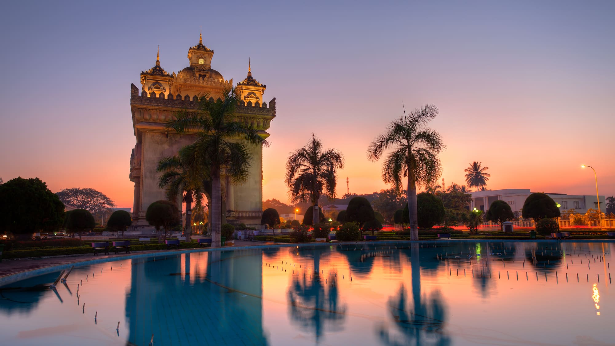 a large building with a pool in front of it