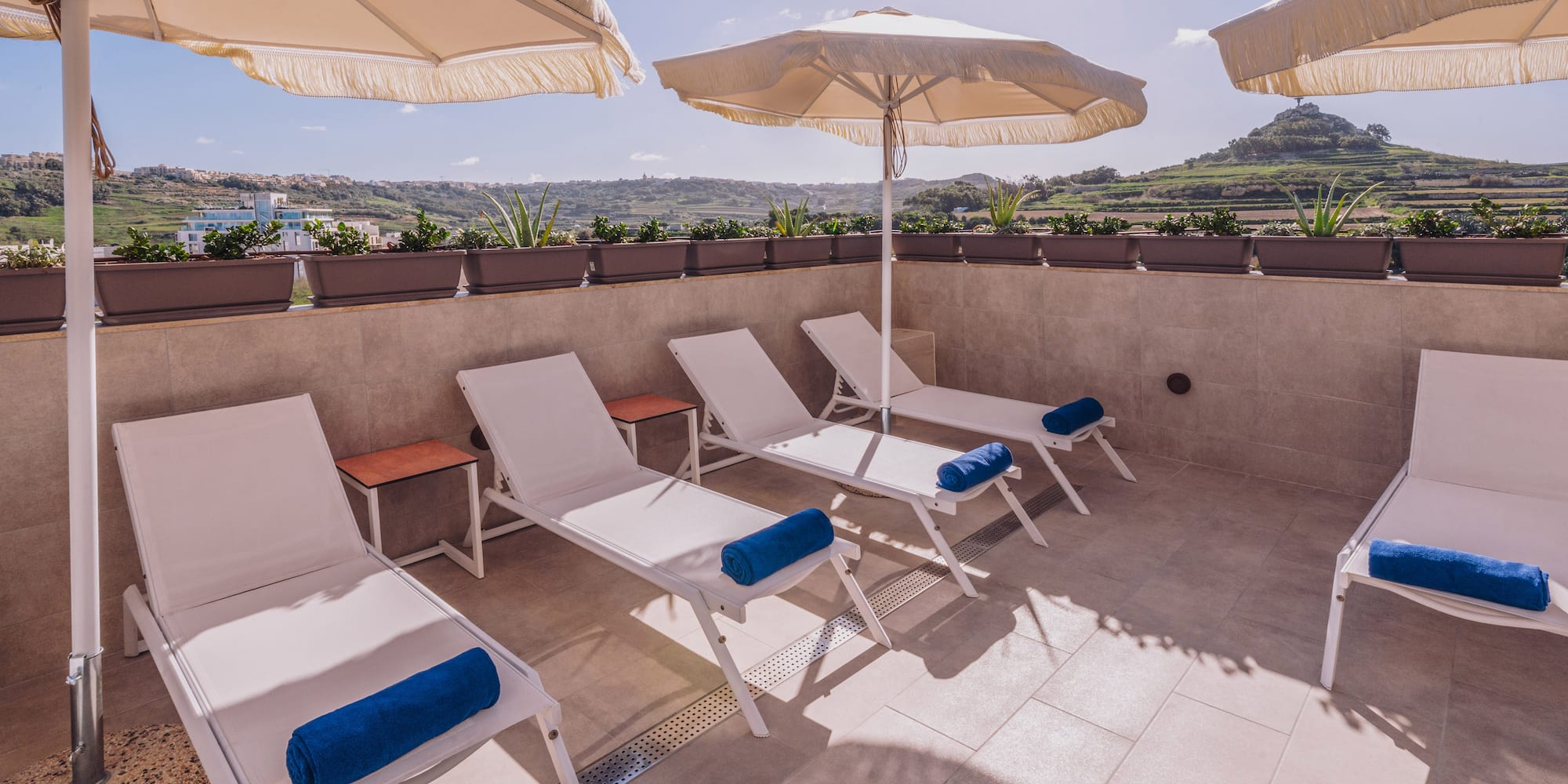 a group of chairs and umbrellas on a patio
