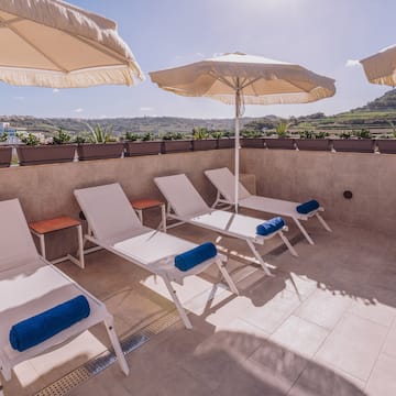 a group of chairs and umbrellas on a patio