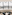 Panoramic London city view from modern lounge with telescope and black chairs.