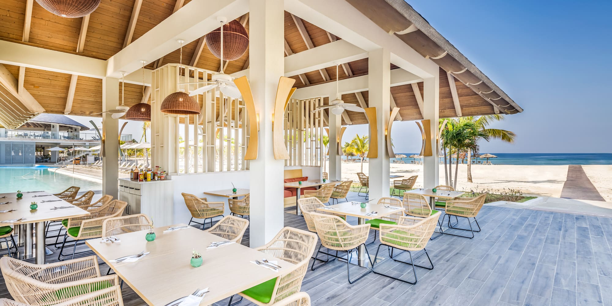 a restaurant with tables and chairs on a deck