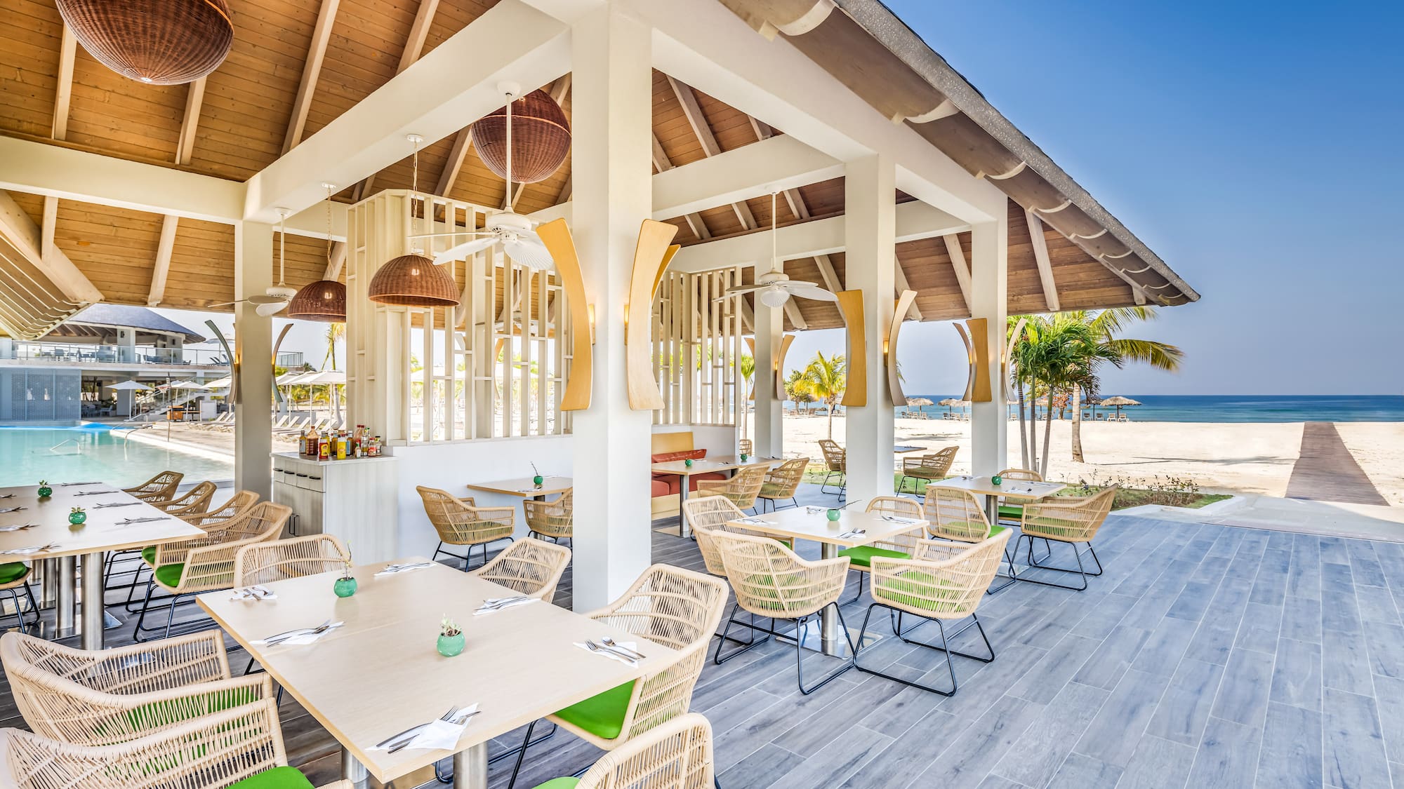a restaurant with tables and chairs on a deck
