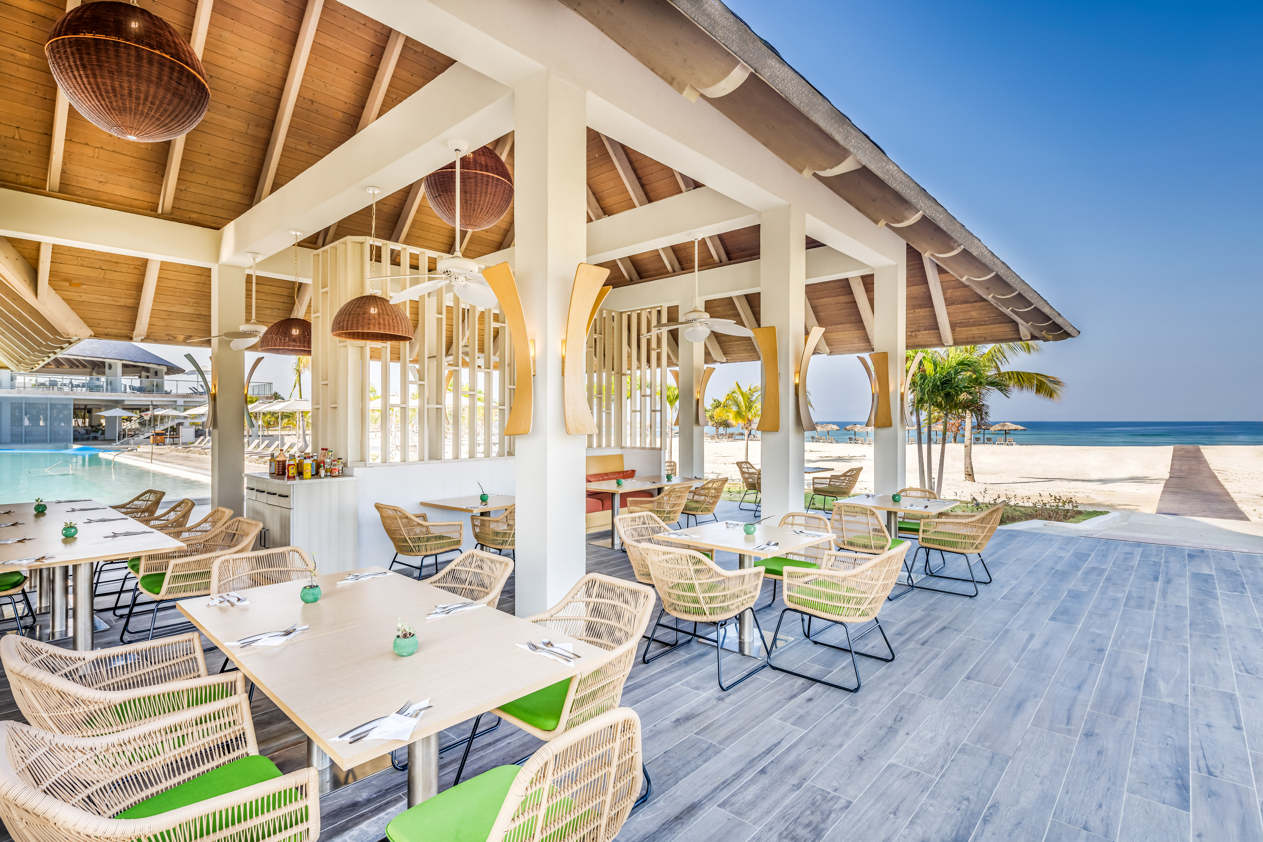 a restaurant with tables and chairs on a deck