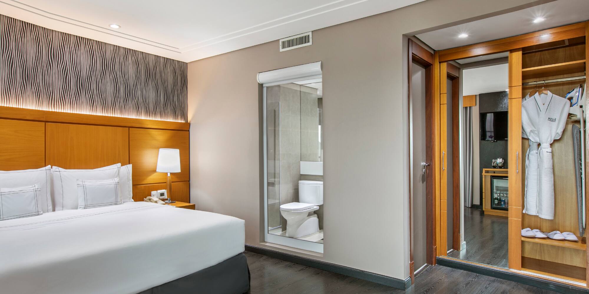 a bedroom with a bed and a toilet