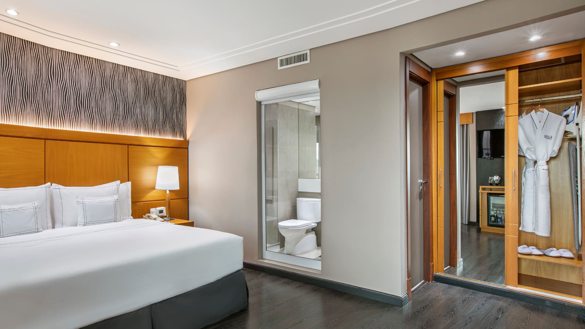 a bedroom with a bed and a toilet