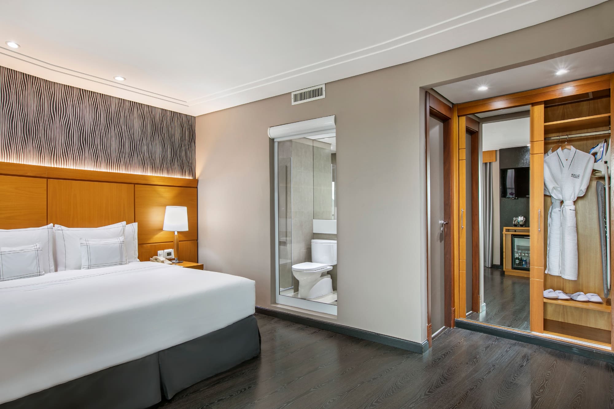 a bedroom with a bed and a toilet