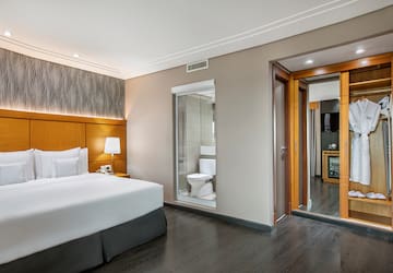 a bedroom with a bed and a toilet