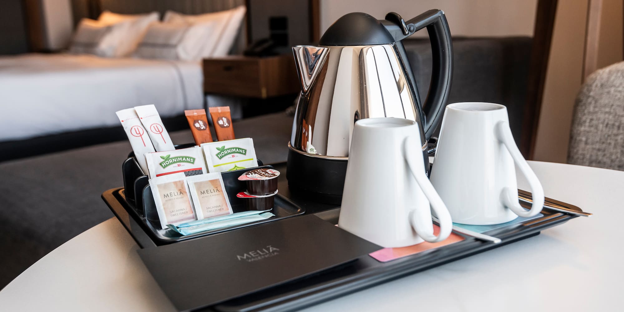 a tray with coffee and tea items on it.