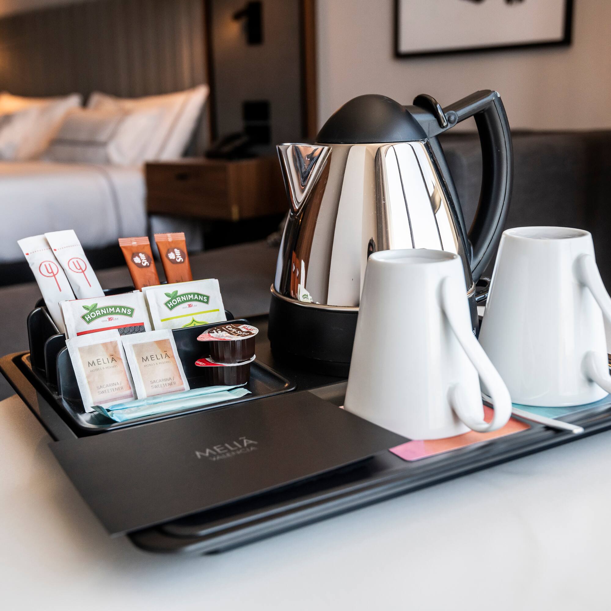 a tray with coffee and tea items on it.