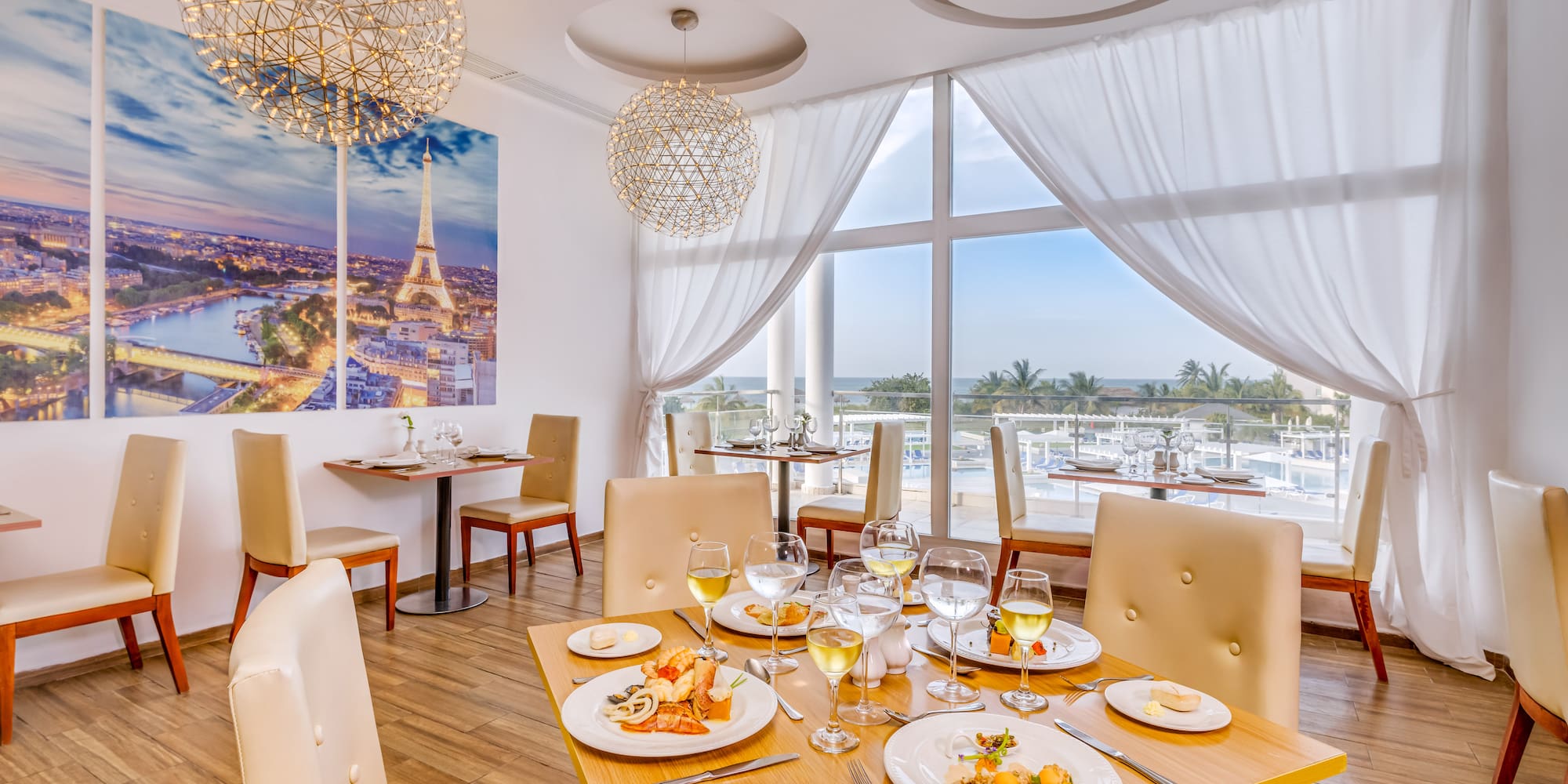 a table with food on it and a chandelier from the ceiling