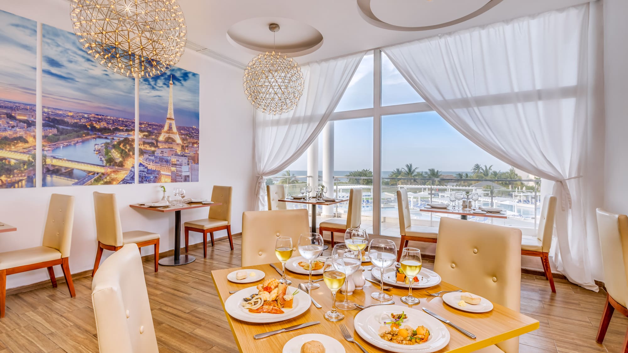 a table with food on it and a chandelier from the ceiling