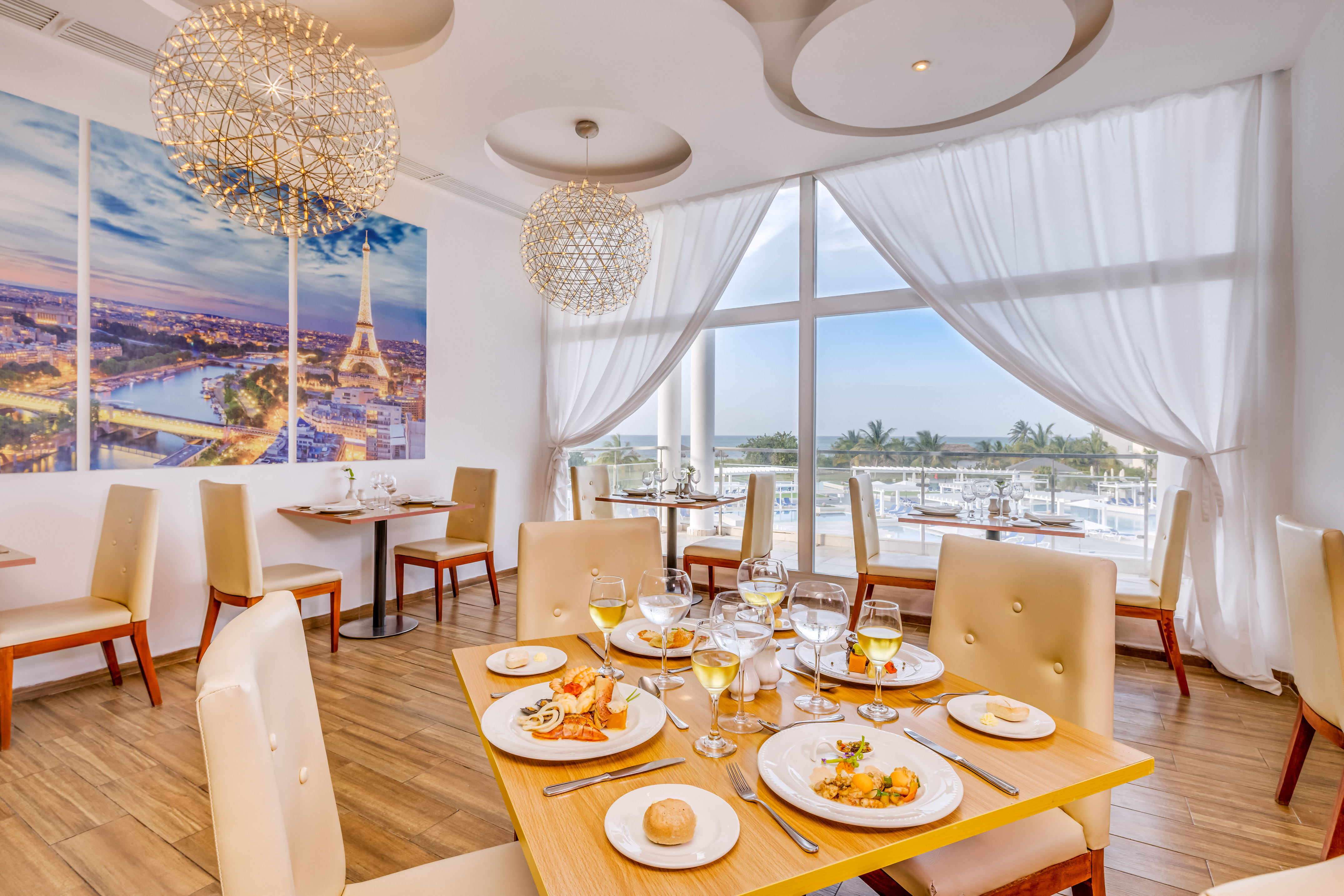 a table with food on it and a chandelier from the ceiling