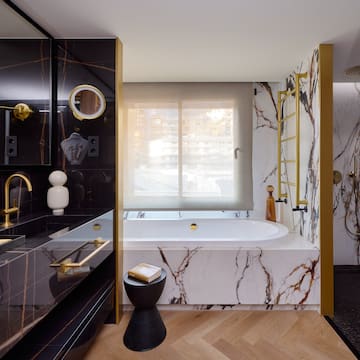a bathroom with marble and gold accents