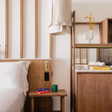 a bedroom with a bed and shelves